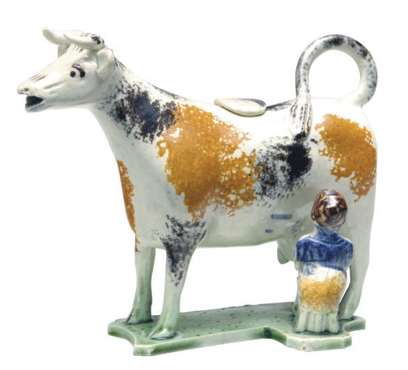 AN ENGLISH PEARLWARE CREAMER AND COVER AS A MILKING GROUP,