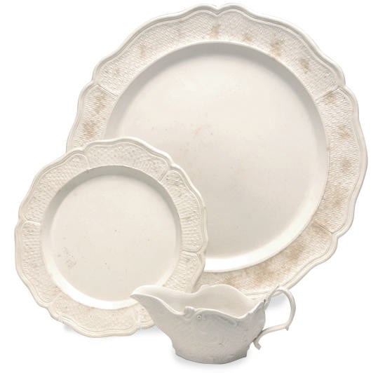 A STAFFORDSHIRE WHITE SALTGLAZE STONEWARE SILVER-SHAPED CHARGER, TWO PLATES, AND A SAUCEBOAT,