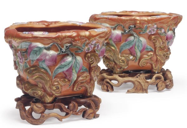 A PAIR OF CHINESE PORCELAIN ORANGE-GROUND FLOWER POTS ON WOOD STANDS,