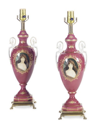 A PAIR OF CLARET-GROUND PORCELAIN DOUBLE-HANDLED VASES MOUNTED AS LAMPS,