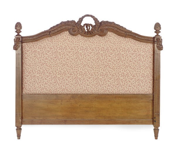 A STAINED FRUITWOOD UPHOLSTERED HEADBOARD,