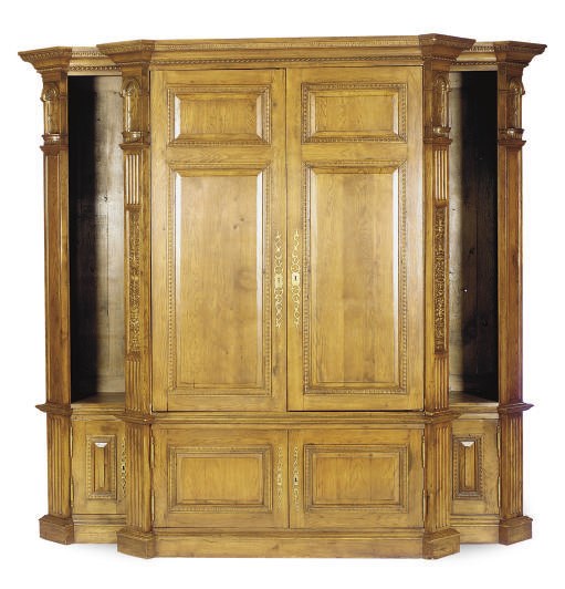 A CARVED OAK LIBRARY CABINET,