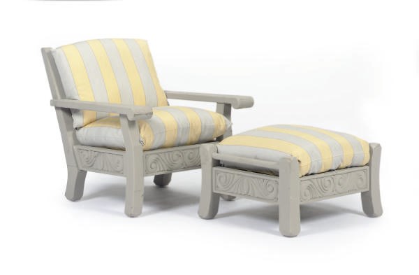 A PAIR OF TEAK ARMCHAIRS TOGETHER WITH AN OTTOMAN AND LOW CIRCULAR TABLE,