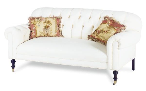 A BUTTON-TUFTED WHITE UPHOLSTERED SOFA,