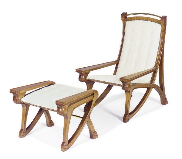 AN OAK PLANTATION ARMCHAIR AND FOOTSTOOL,