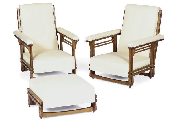 A PAIR OF OAK PLANTATION ARMCHAIRS TOGETHER WITH AN OTTOMAN,