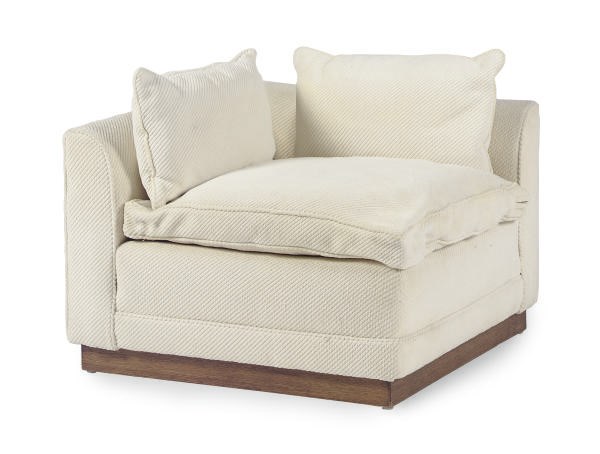 AN UPHOLSTERED CORNER CHAIR,