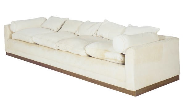 AN UPHOLSTERED FOUR-SEAT SOFA,
