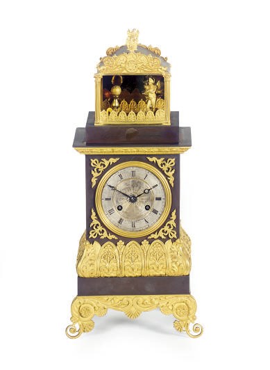 A FRENCH RESTAURATION PATINATED AND GILT-METAL FIGURAL MANTELCLOCK,