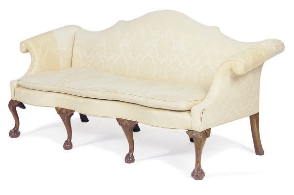 A WALNUT AND UPHOLSTERED CAMELBACK SERPENTINE SOFA,