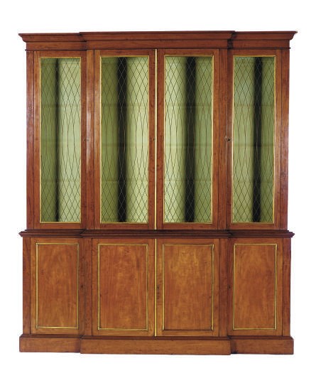 AN ENGLISH MAHOGANY AND PARCEL-GILT BREAKFRONT BOOKCASE,