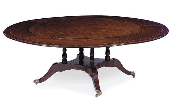 A MAHOGANY AND ROSEWOOD BANDED CIRCULAR EXTENSION DINING TABLE**,