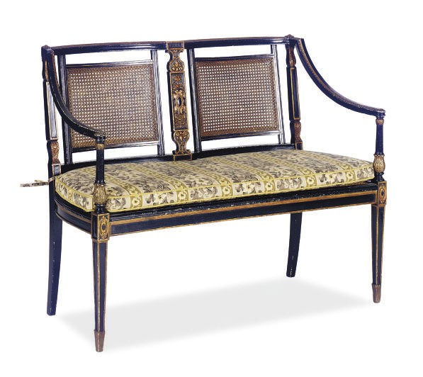 AN EBONIZED, PARCEL-GILT AND CANED DOUBLE CHAIR BACK SETTEE,