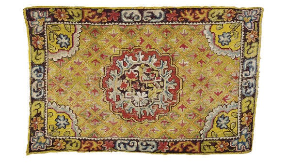 A CONTINENTAL NEEDLEWORK RUG,