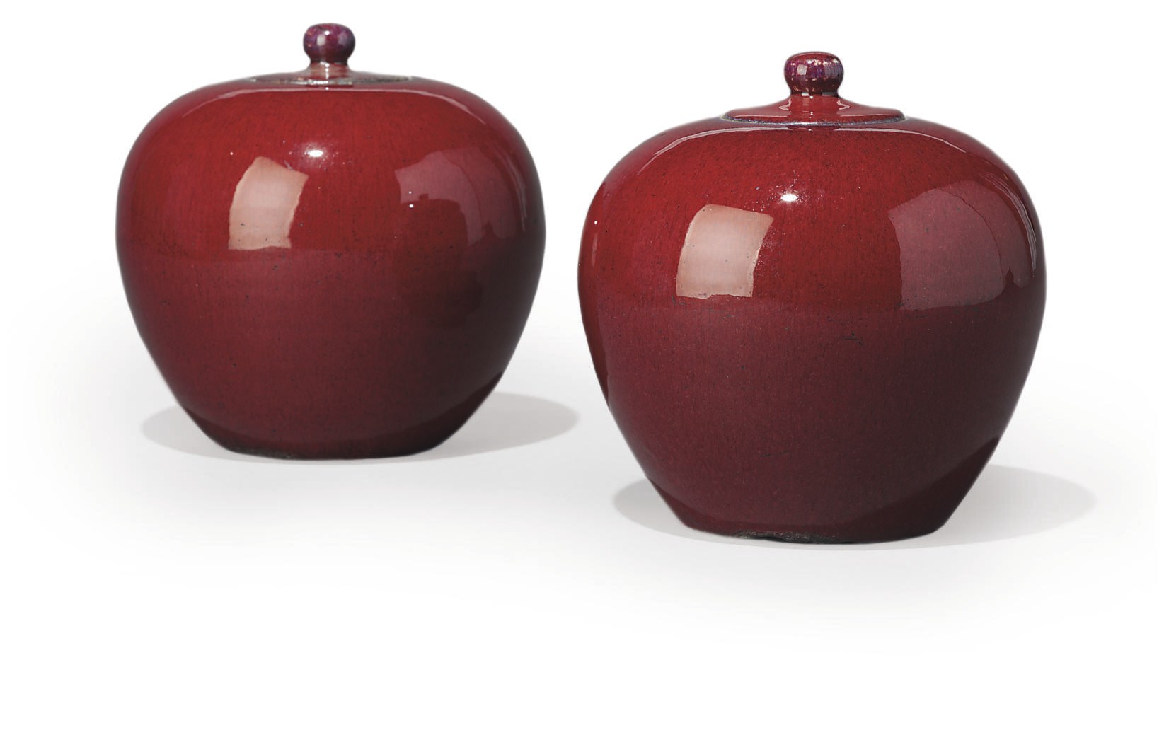 A PAIR OF CHINESE FLAMBÉ JARS AND COVERS