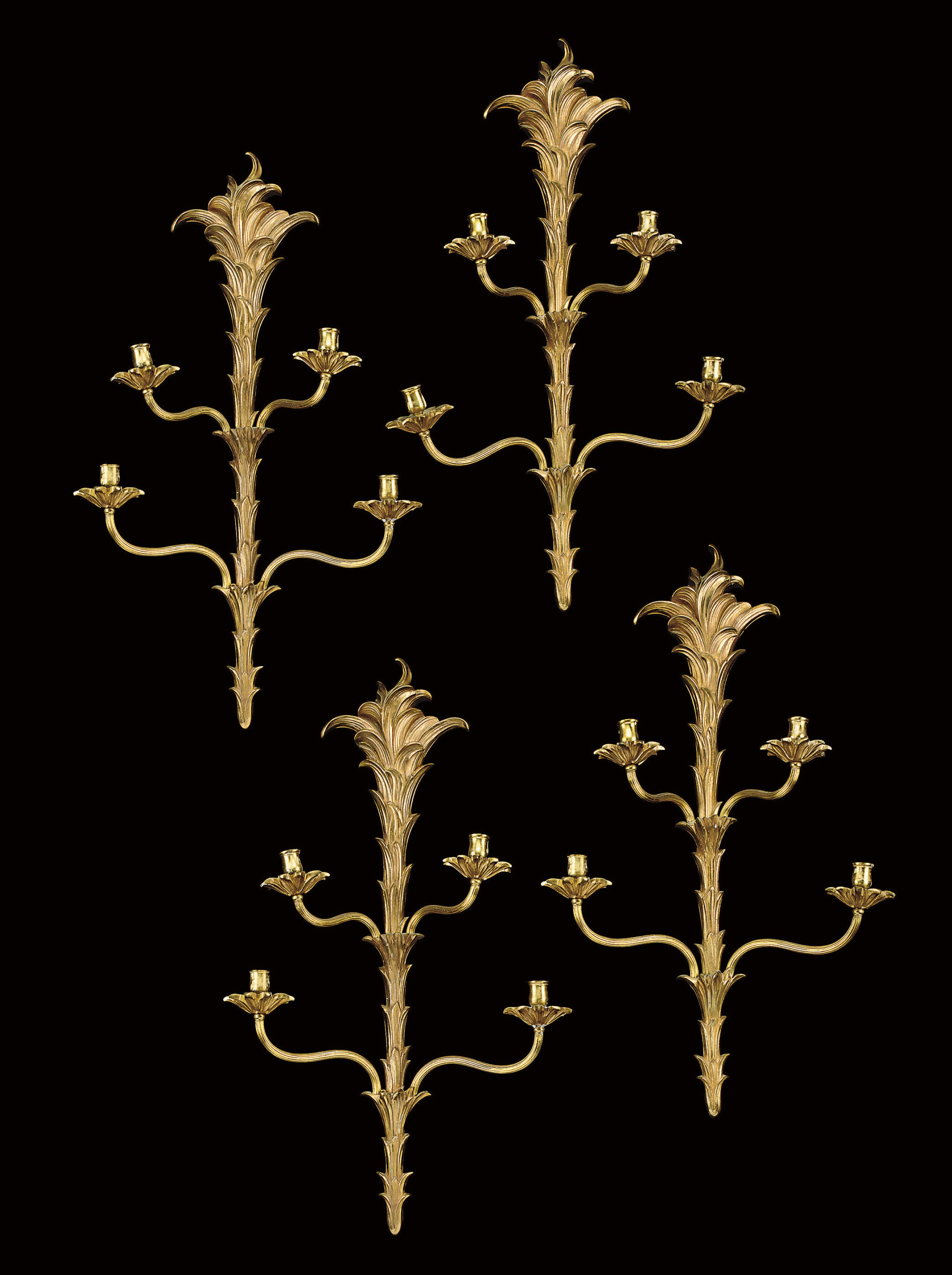 A SET OF FOUR VARNISHED BRONZE FOUR-LIGHT WALL LIGHTS