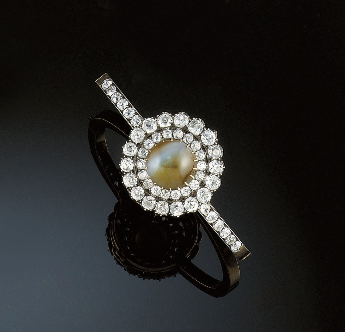 A late 19th century chrysoberyl cat's eye and diamond bangle