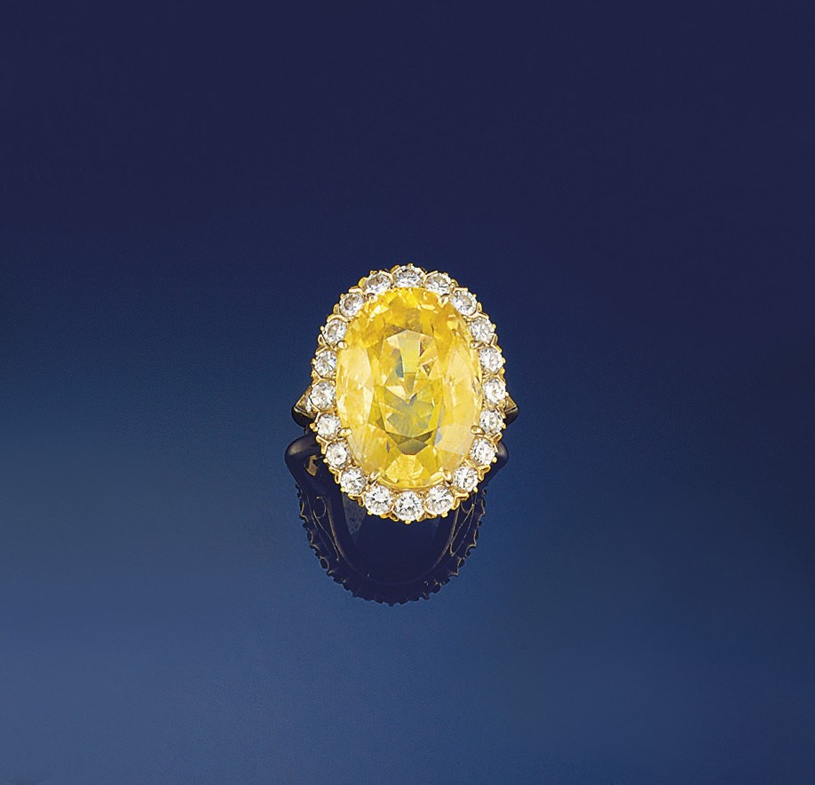 A yellow sapphire and diamond cluster ring