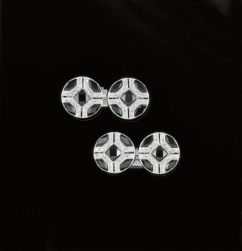 A pair of onyx and diamond cufflinks