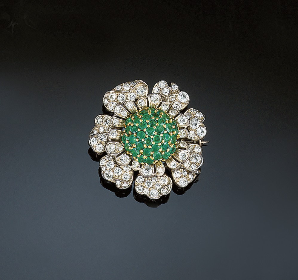 A diamond and emerald brooch