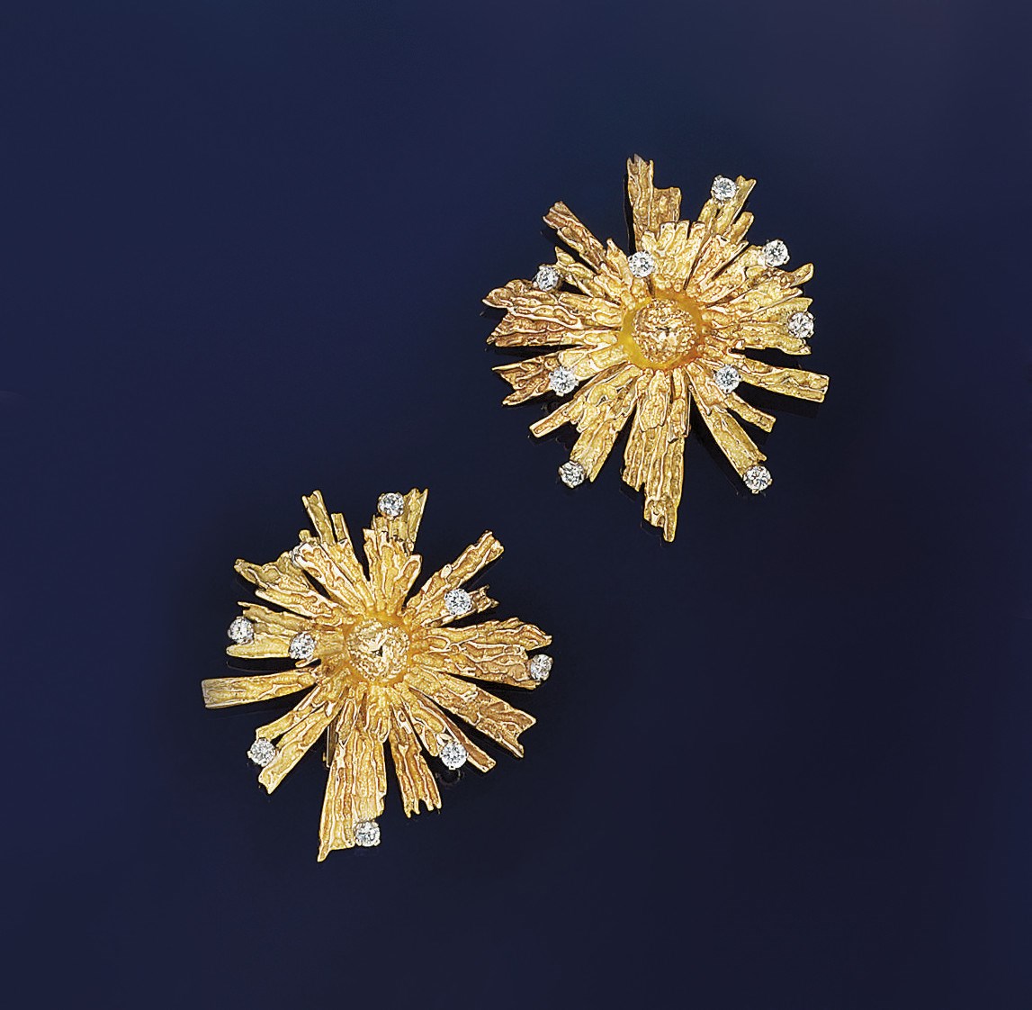 A pair of diamond set earclips, by Cartier