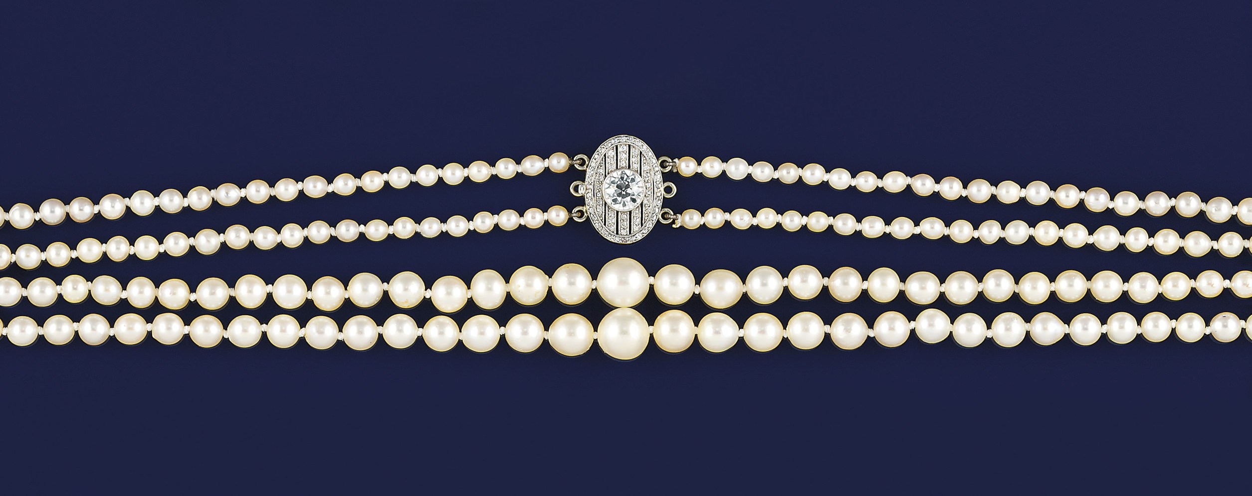 A cultured pearl necklace with a belle epoque diamond clasp
