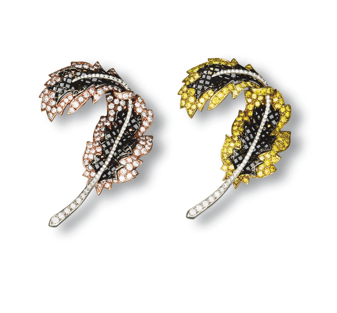A PAIR OF DIAMOND AND COLOURED DIAMOND LEAF BROOCHES, BY CARNET
