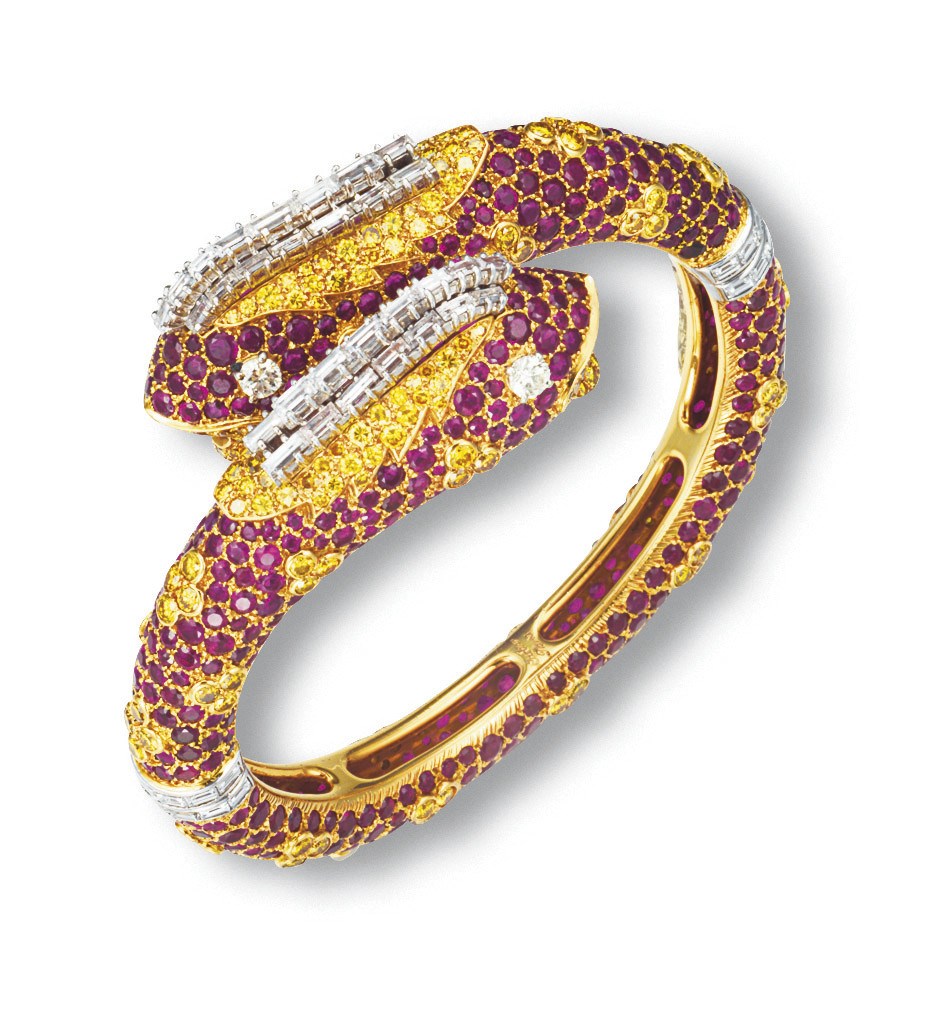AN UNUSUAL RUBY, COLOURED DIAMOND AND DIAMOND 'CHIMAERA' BANGLE, BY CARTIER