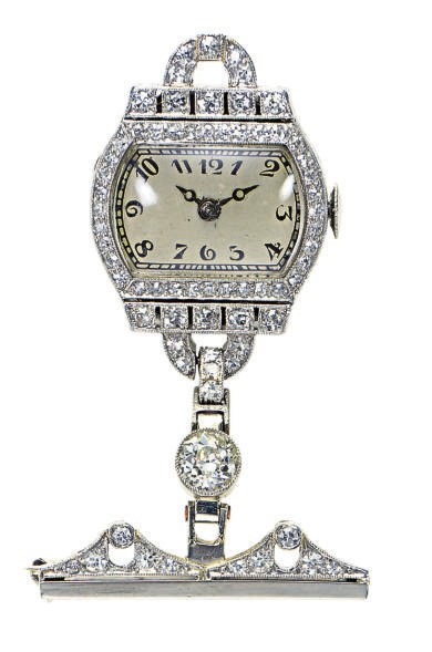 A DIAMOND AND PLATINUM LAPEL WATCH