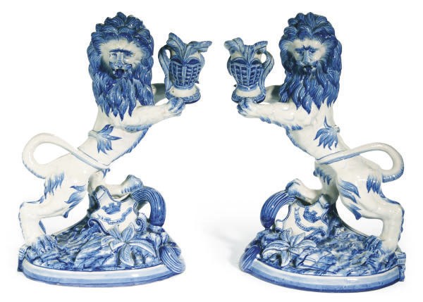 A PAIR OF FRENCH FAIENCE LION-FORM CANDLESTICKS,