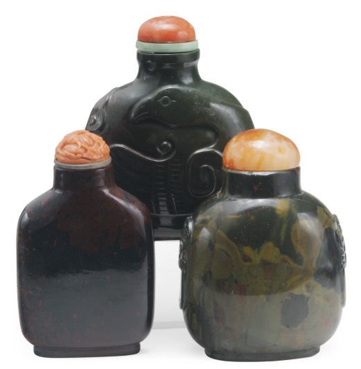 THREE CHINESE JASPER SNUFF BOTTLES AND CORAL STOPPERS,