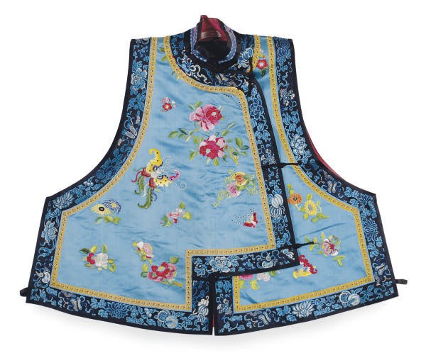 A CHINESE EMBROIDERED SILK BLUE GROUND VEST WITH GILT THREADS AND PEONY AND BUTTERFLIES,