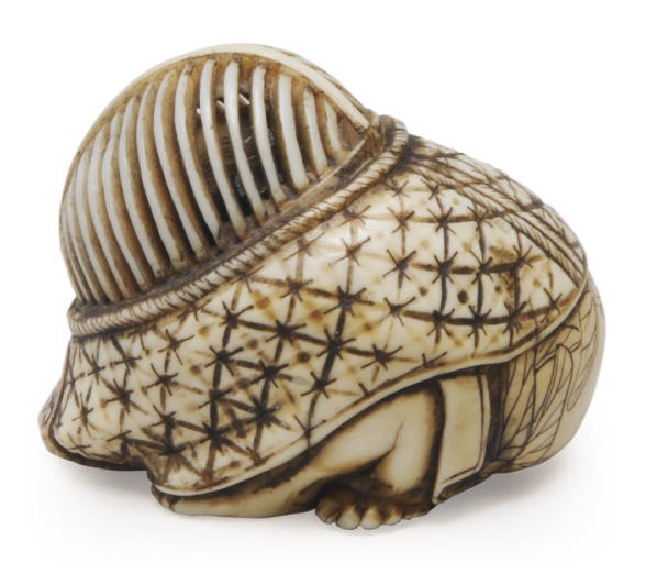 A JAPANESE IVORY NETSUKE OF A BOY HIDING BENEATH A KENDO MASK,**