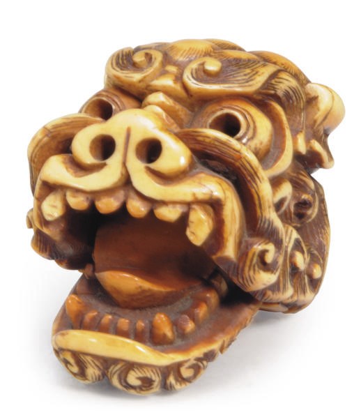 A JAPANESE IVORY NETSUKE OF A SHI SHI MASK,**