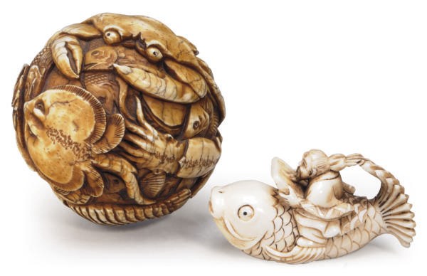 A JAPANESE IVORY TABLE ORNAMENT CARVED WITH CRUSTANCEANS, FISH, AND RAYS AND A NETSUKE OF SEN'NIN ON A CARP,**