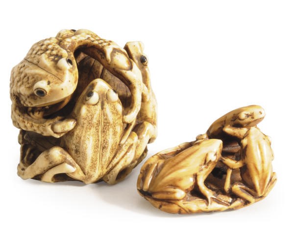 TWO JAPANESE IVORY MODELS OF FROGS ON LILY PADS,**