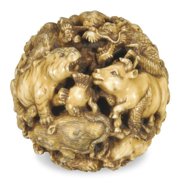 A JAPANESE IVORY TABLE ORNAMENT CARVED WITH THE TWELVE ANIMALS OF THE ZODIAC,**