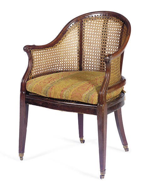 AN ENGLISH MAHOGANY AND CANED LIBRARY ARMCHAIR,