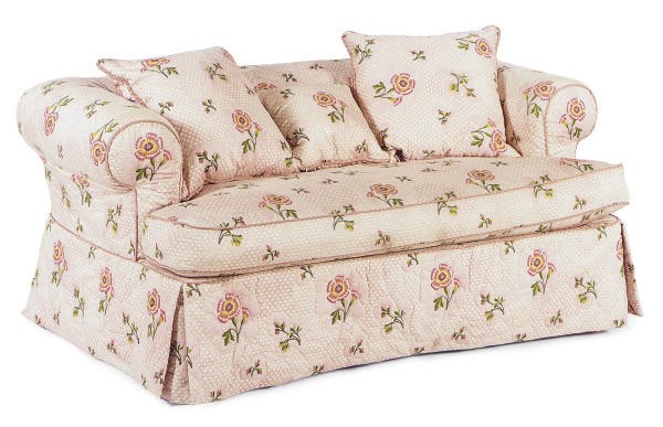 A PINK FLORAL COTTON UPHOLSTERED SMALL SOFA,