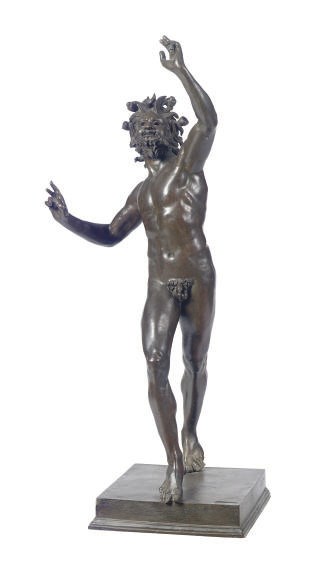 A PATINATED BRONZE FIGURE OF A DANCING FAWN,