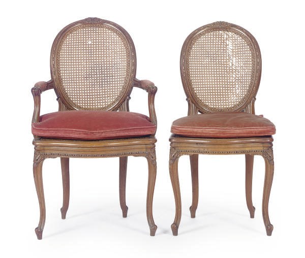 A SET OF TWELVE OAK AND CANED DINING CHAIRS,