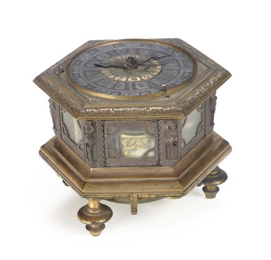 A GERMAN ENGRAVED BRASS QUARTER-STRIKING HEXAGONAL TABLE CLOCK WITH ALARM,