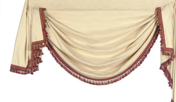 A GROUP OF CREAM AND ROSE TASSEL TRIM CURTAIN PANELS AND PELMETS,