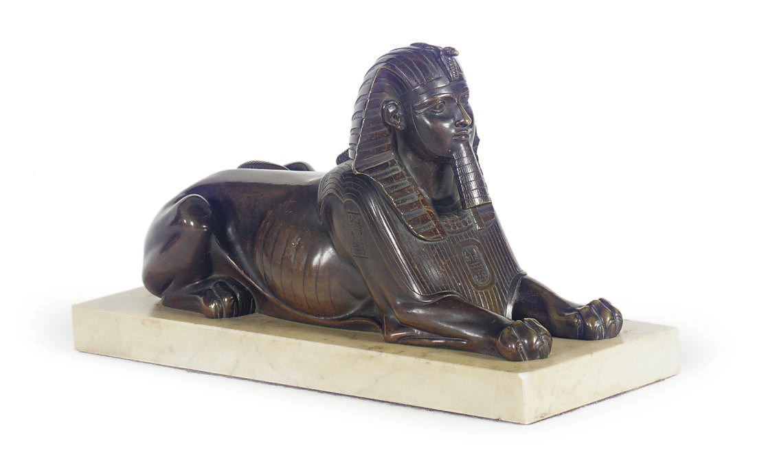 A PATINATED BRONZE SPHYNX,