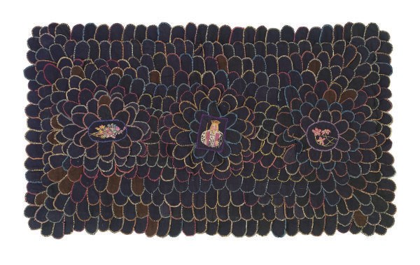 A COTTON AND WOOL NEEDLEPOINT PENNY RUG,