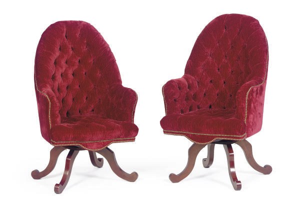 A SET OF THREE BUTTON-TUFTED BURGUNDY VELVET AND MAHOGANY SWIVEL CHAIRS,