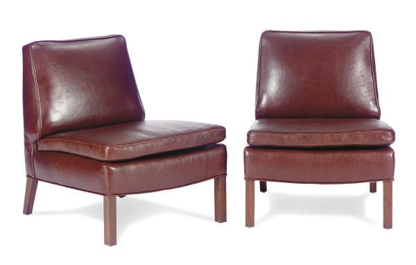 A PAIR OF WALNUT AND LEATHER-UPHOLSTERED LOUNGE CHAIRS,