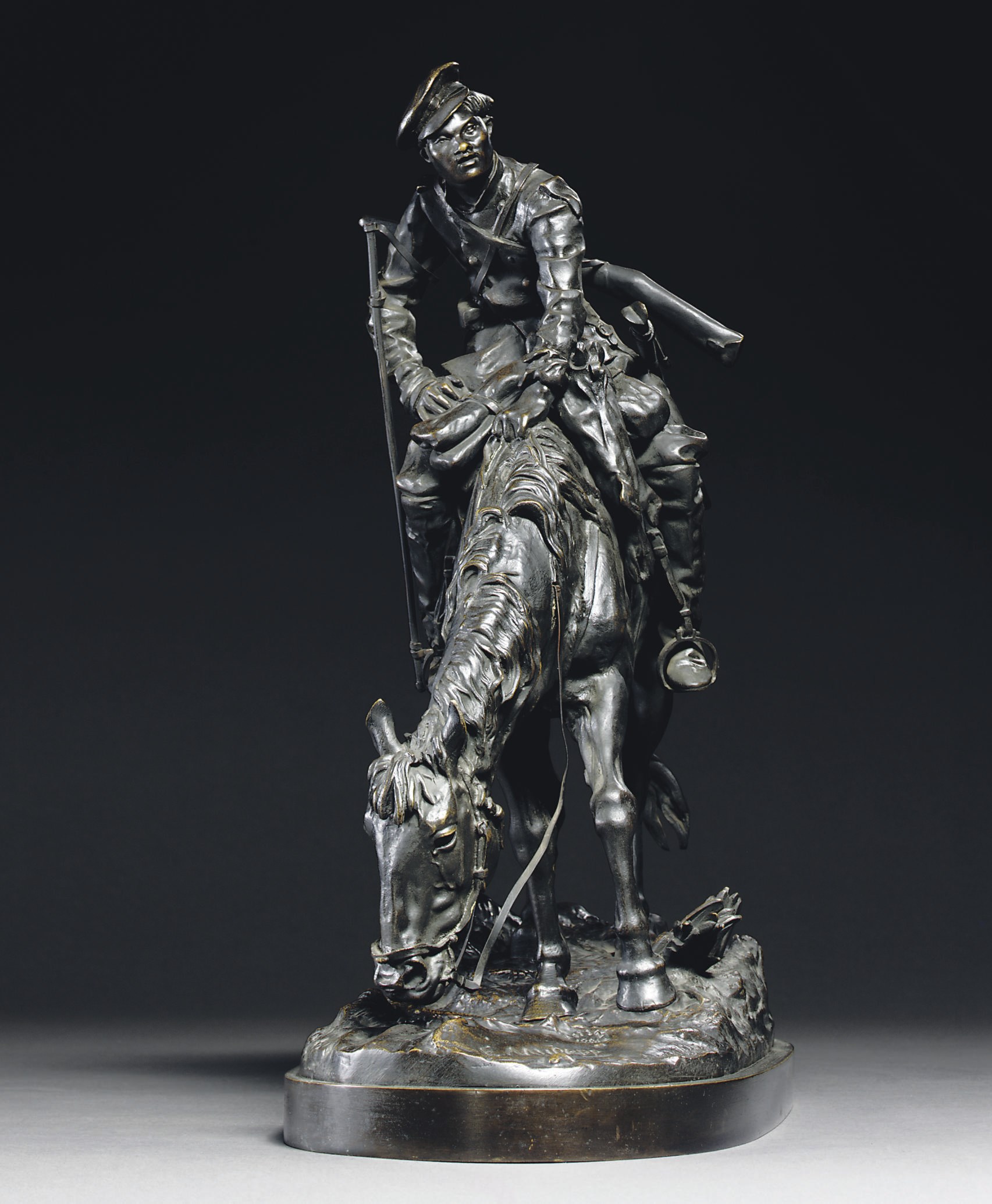 A bronze figure of a Cossack on a horse