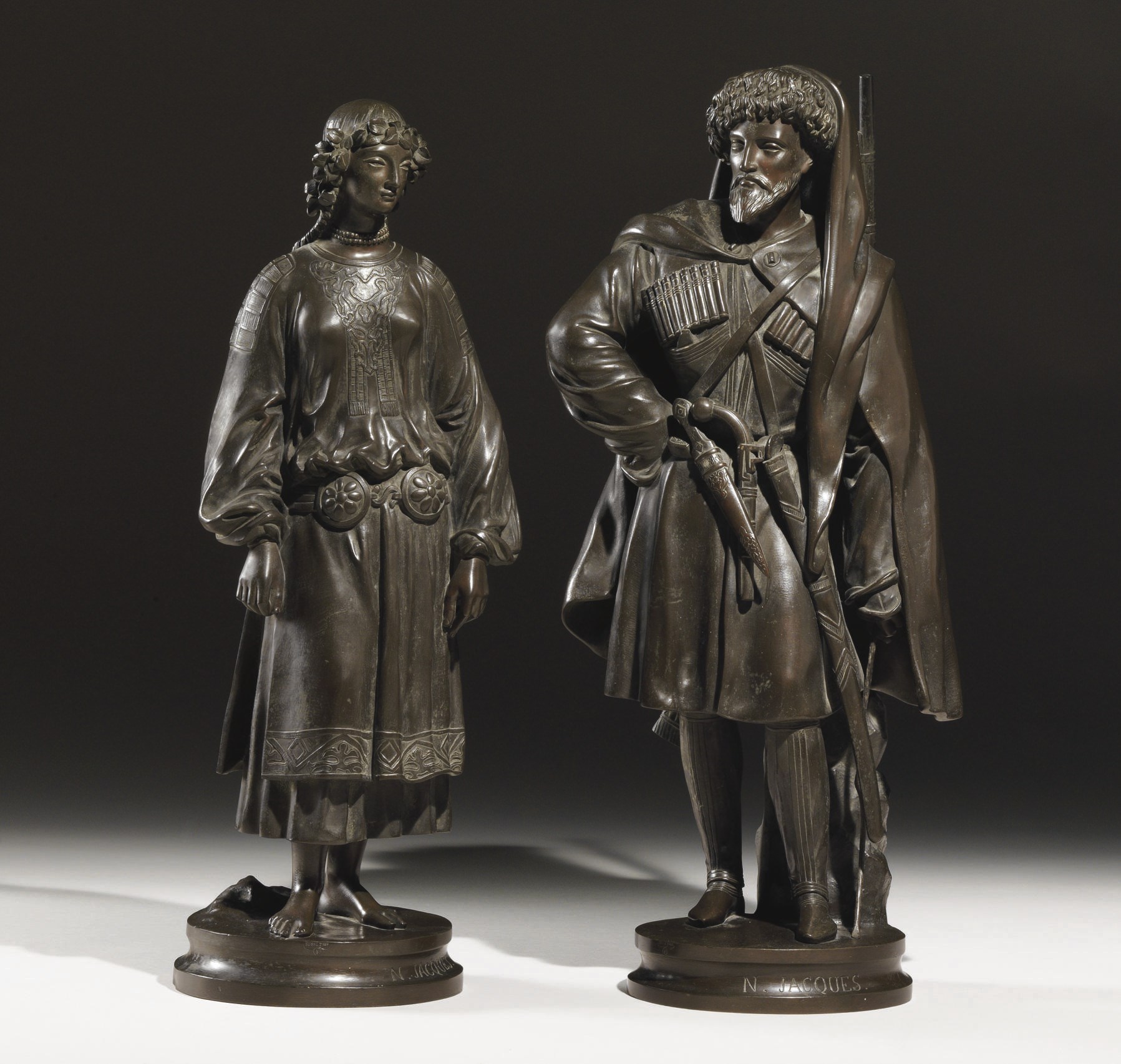 A pair of bronze figures of a Caucasian Man and Woman