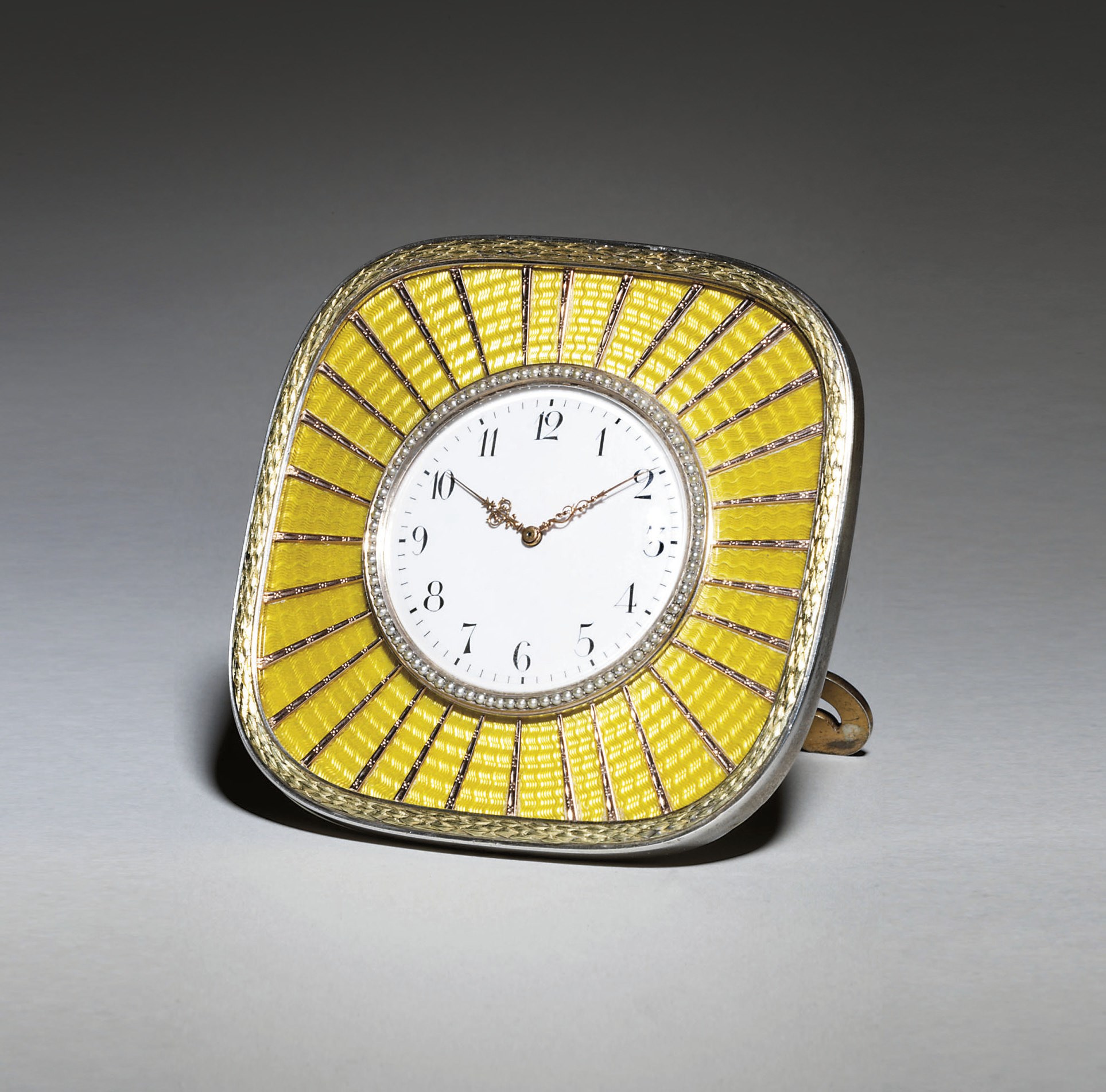 A silver-gilt and gold-mounted guilloché enamel sunburst clock